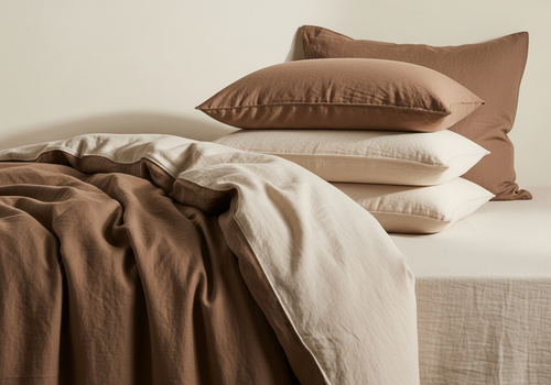Warm taupe linen duvet styled on a bed, lifestyle