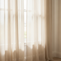 Ivory sheer linen curtain panel diffusing daylight